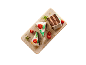 Chokoladekage med hvid glasur, hindbær og mynte på en rektangulær tallerken.