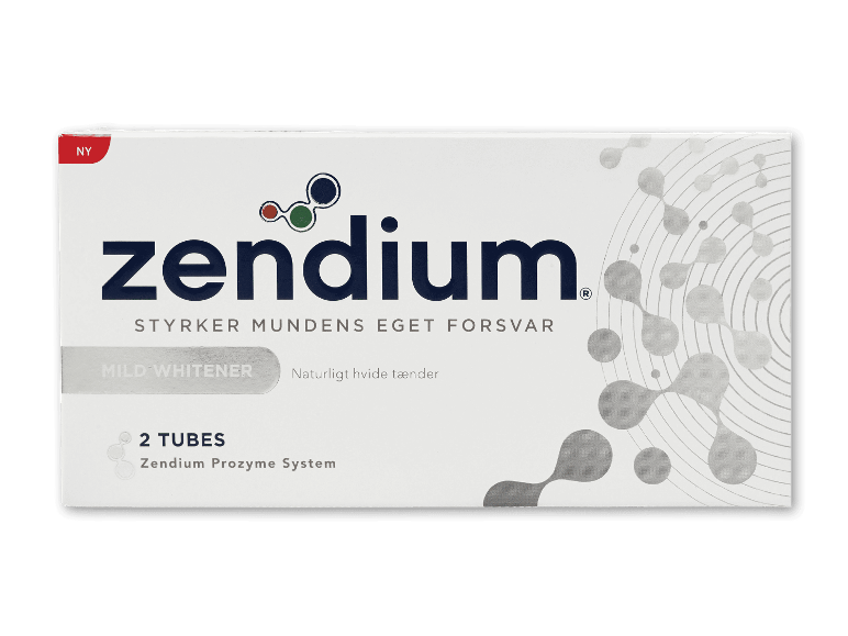 Hvid æske tandpasta med tekst: 'NY', 'MILD WHITENER', '2 TUBES', 'Zendium Prozyme System'