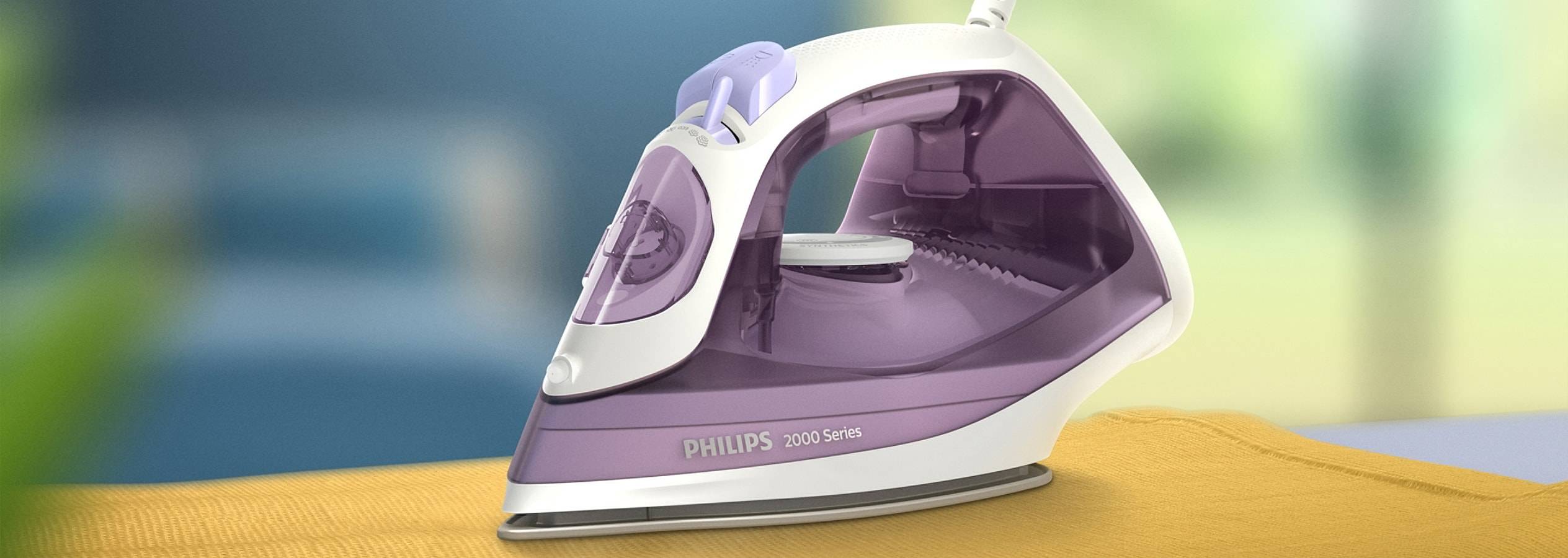 En Philips 2000 Series strygejern hviler på et gulligt stof.