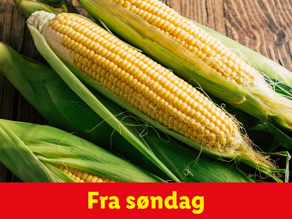 Majskolber på træbord med teksten 'Fra søndag'.