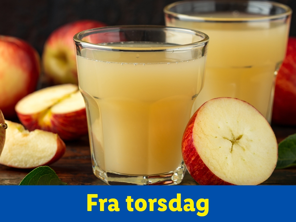 Æblejuice i glas med friske æbler.