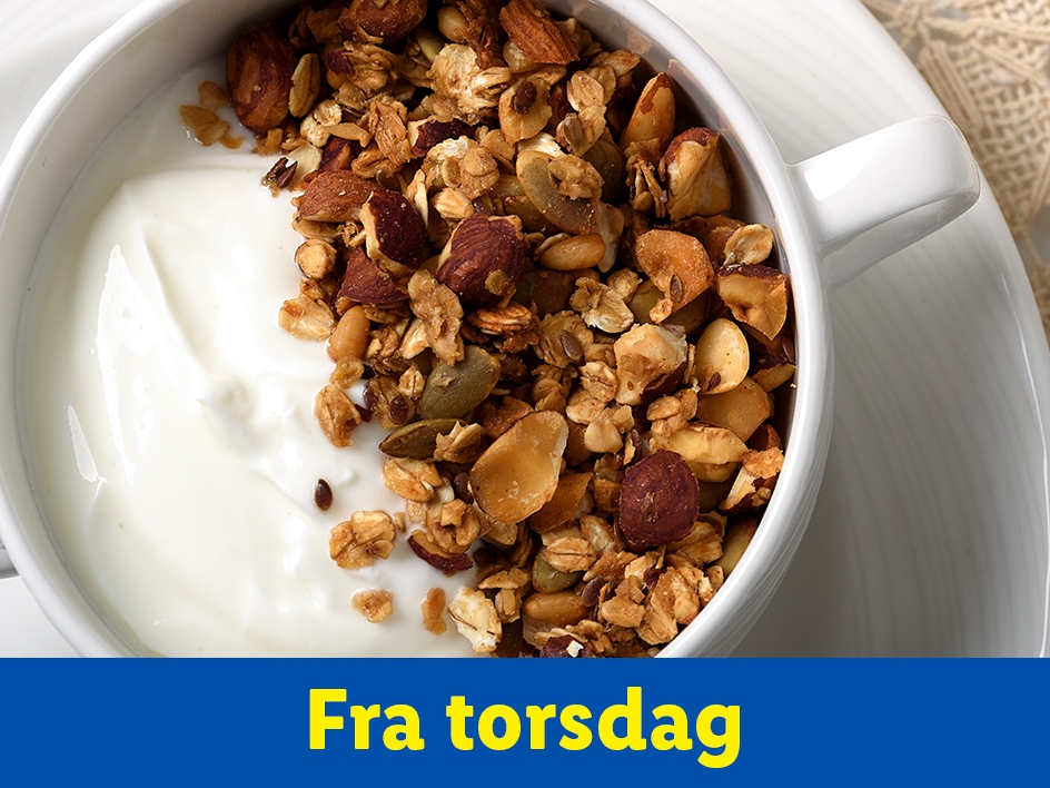 En hvid skål med yoghurt og granola med nødder og frø, med teksten 'Fra torsdag'.