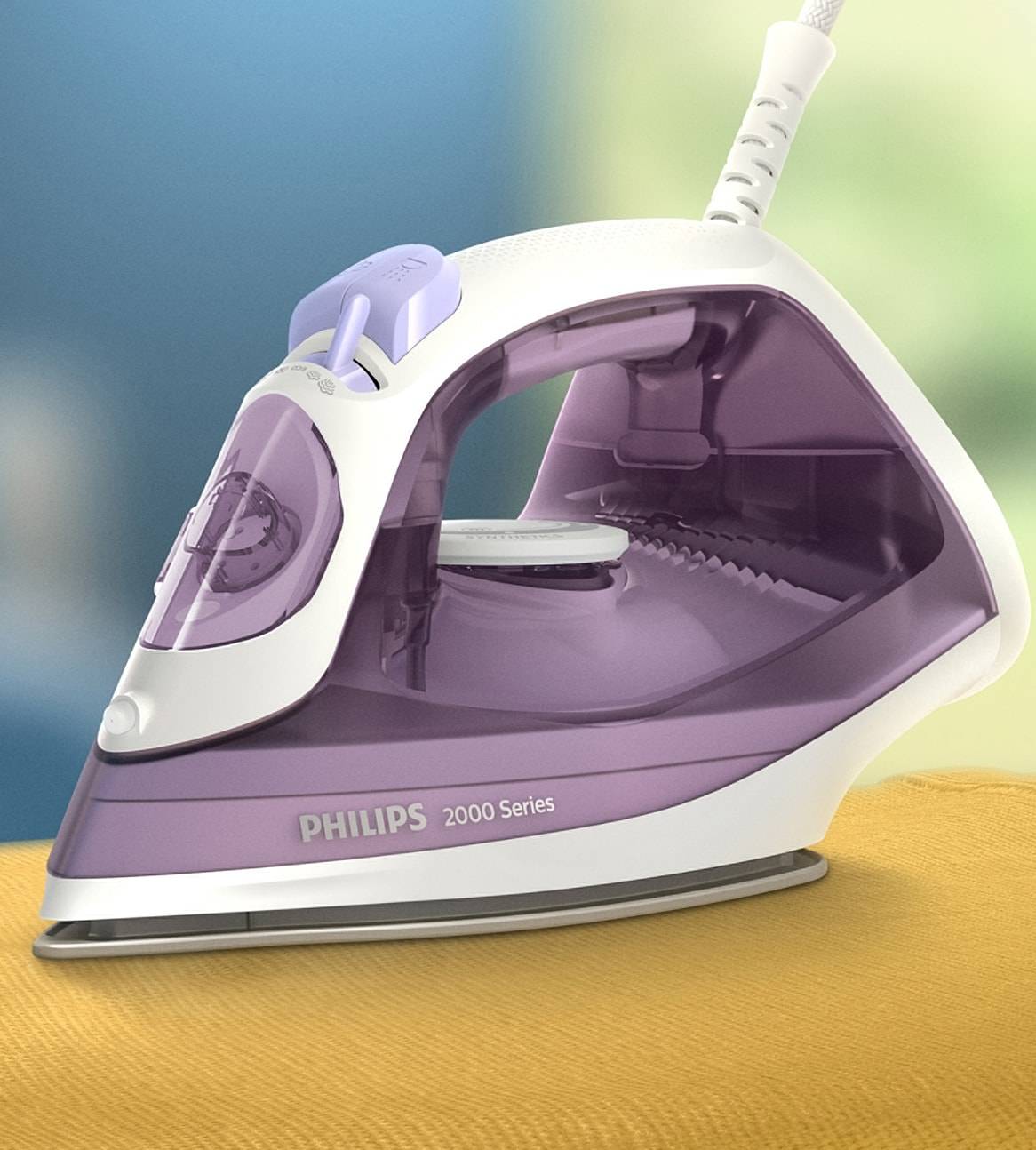 En lilla og hvid Philips 2000 Series strygejern på et gulligt stof.