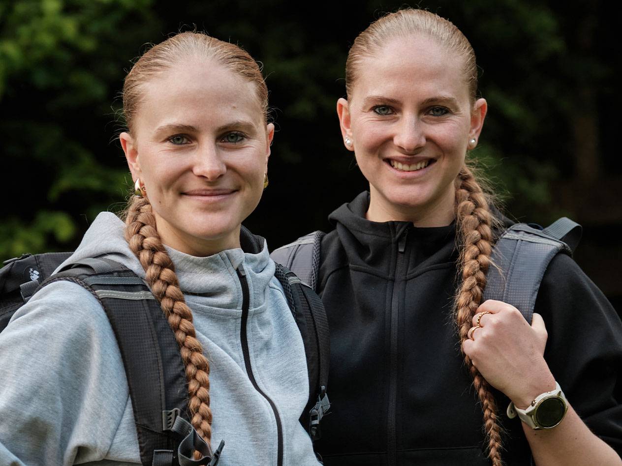 To kvinder med rygsække står sammen.